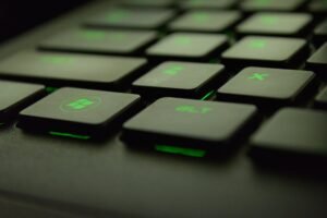 close up photography of black and green computer keyboard keys